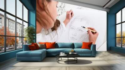 Artist drawing pencil portrait close-up. Woman painter creating picture of woman on big whatman. Art, talent, craft, hobby, occupation concept Wall mural