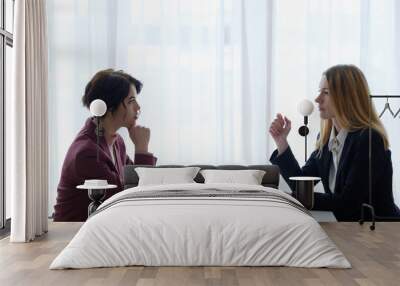 business negotiation communication. two women confronting each other in boarding room. office workspace Wall mural