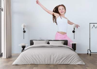 child jumping high in the air. aireness lightness freedom happiness and carefree childhood emotion concept. little girl on white background Wall mural