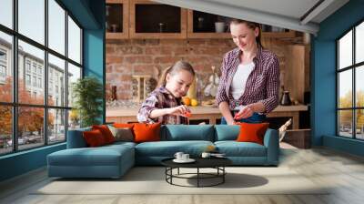 happy family cooking time. mom and daughter preparing meal in the home kitchen Wall mural