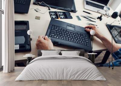 Keyboard of disassembled laptop, repairman pov. Engineer workplace with necessary tools. Electronic repair shop, business, occupation concept Wall mural