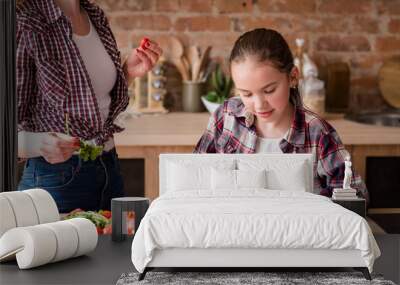 little cook. adolescent girl cutting vegetables and preparing dinner from fresh organic food ingredients. healthy eating and wholesome nutrition concept. Wall mural