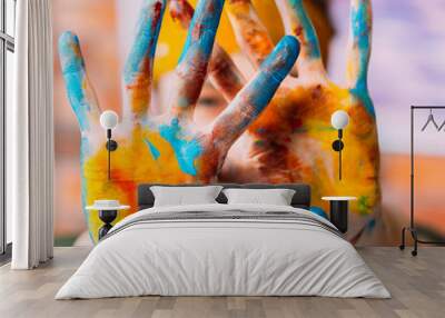 Modern fine art course. Closeup of female hands dirty with colorful paint. Blur background. Wall mural