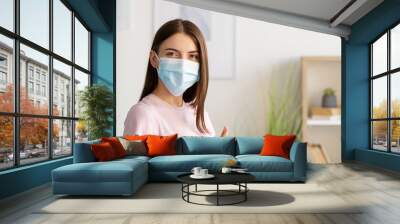 Pandemic protection. Female patient. Vaccination result. Satisfied woman medicine mask after injection showing like in light hospital room interior. Wall mural