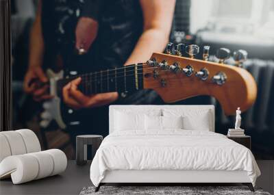 rock band studio rehearsal. male musician playing bass guitar before live concert. Wall mural