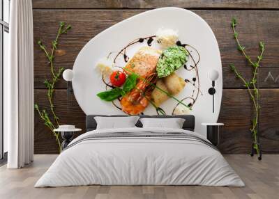 Seafood variety on white plate flat lay. Top view on white triangle plate with different seafood products on wooden background Wall mural