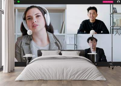 Webinar meeting. Foreign training. Screen mockup. Curious woman in headphones talking with two men having online conference in light room interior. Wall mural