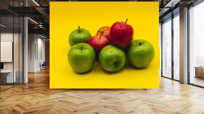 green apples and red apples on yellow background Wall mural