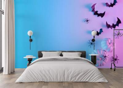 Creative flat lay Halloween background with bats silhouettes and pumpkins painted in vibrant gradient holographic neon colors. Copy space. Minimal season holiday concept. Wall mural