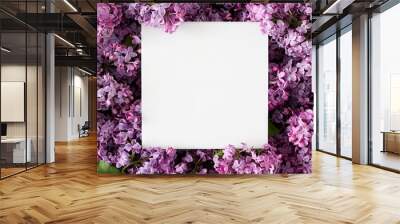 Creative layout made of flowers and leaves with note paper card. Nature concept. Flat lay. Wall mural