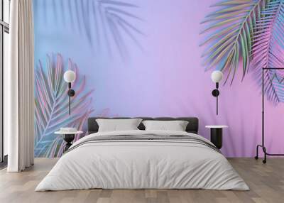 Creative layout made of tropical leaves and shadows in vibrant gradient holographic neon colors. Flat lay. Minimal surreal summer background with copy space. Border arrangement. Wall mural