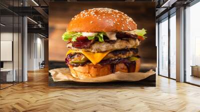 Grilled chicken burger with double cutlet, cheese and vegetables on a wooden table. Grilled cheeseburger. Fast food takeaway. Wall mural