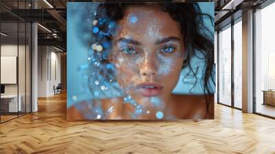 A woman's face covered with sparkling makeup and splashes, showcasing a blend of beauty and digital art Wall mural