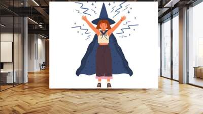 Cute girl in witch hat and cloak conjures. Young female wizard or sorcerer casts spell with raised hands. Young magician with red hair. Flat vector cartoon illustration isolated on white Wall mural