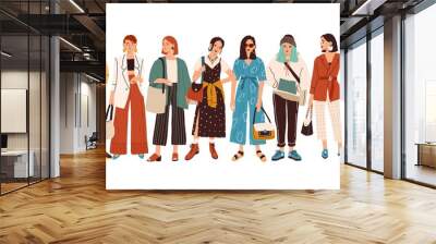 Group of fashionable women standing together vector flat illustration. Stylish female characters in modern casual, hipster clothes isolated on white. Beautiful ladies in elegant outfit Wall mural