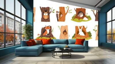 Set of animals and birds inside hollows. Squirrel, owl, woodpecker, hedgehog, raccoon, bat, fox, beaver, hare, and weasel in tree hole houses. Flat vector illustration isolated on white background Wall mural