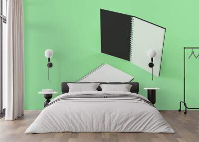 Two notebooks with spiral bound on green background Wall mural