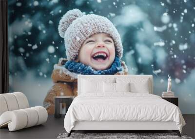 Child in brown coat and pom-pom hat in snowy play. Wall mural