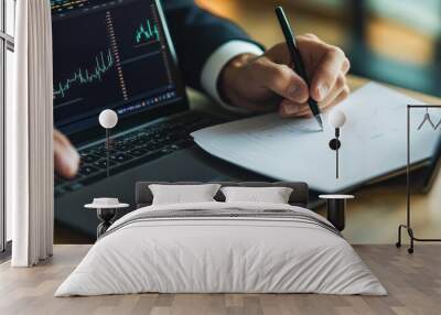 Detailed financial analysis on laptop with handwritten notes Wall mural