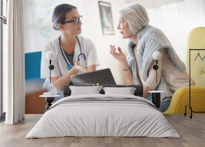  Doctor going through results and medication on tablet with senior patient Wall mural