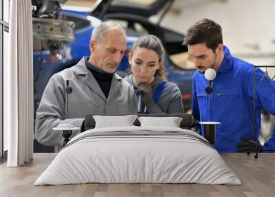 Apprentice with instructor using tablet in workshop Wall mural