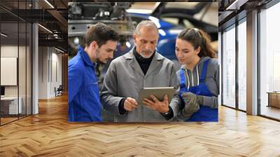 Apprentice with instructor using tablet in workshop Wall mural