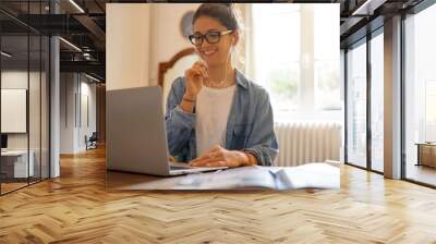 Attractive young woman working from home Wall mural