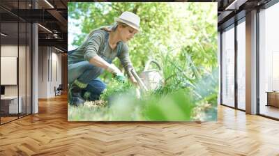 Blond woman with hat gardening Wall mural