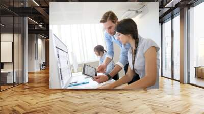 Business people working in office on desktop computer Wall mural