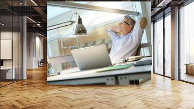 Businessman in office relaxing in desk chair Wall mural