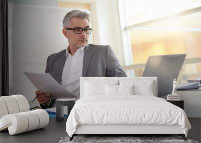 businessman in office working on laptop Wall mural