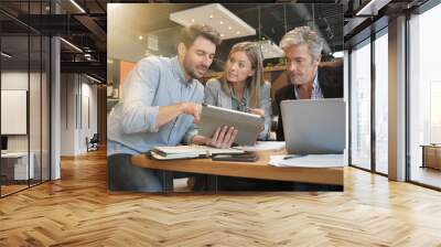 Casual sales team working through presentation with manager Wall mural