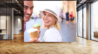 Cheerful couple in Rome eating ice cream cones Wall mural