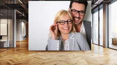 cheerful couple with eyeglasses on white background Wall mural