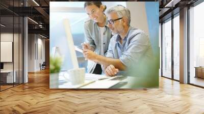 Cheerful coworkers working together in contemporary office Wall mural