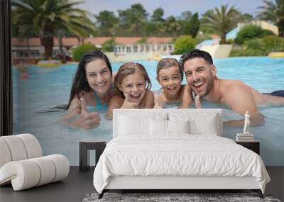 Cheerful family in hotel swimming-pool Wall mural