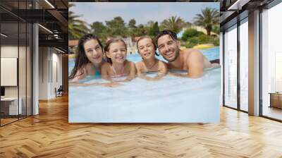 Cheerful family in hotel swimming-pool Wall mural