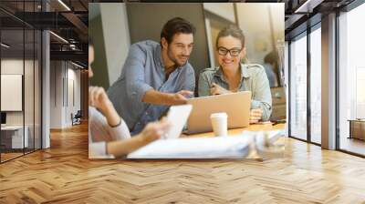 Colleagues workshopping business ideas in modern co working space Wall mural