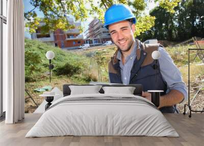 Construction manager using tablet on building site Wall mural