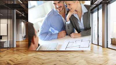 Couple meeting real-estate agent to buy property Wall mural