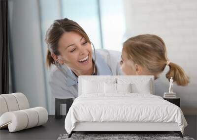 doctor examining little girl with stethoscope Wall mural