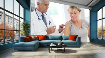 Doctor injecting flu vaccine to patient's arm Wall mural