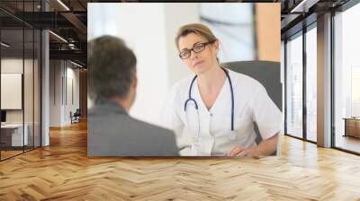 Doctor meeting with patient in hospital office Wall mural