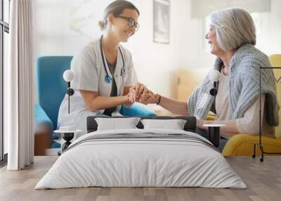 Doctor reassuring older woman in modern clinic Wall mural