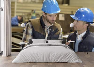 engineer with mechanical worker checking on production Wall mural