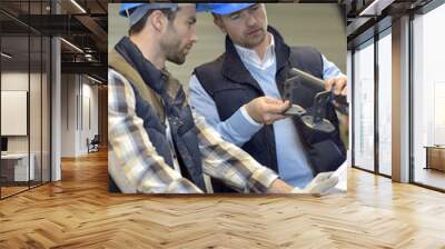 engineer with mechanical worker checking on production Wall mural