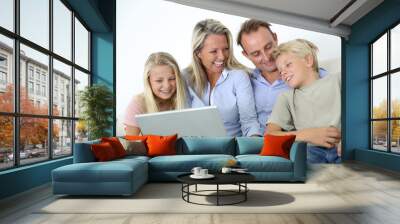 Family connected on internet with laptop Wall mural