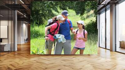 Family rambling in the countryside Wall mural