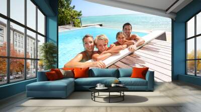 Happy family enjoying bath time in infinity pool Wall mural