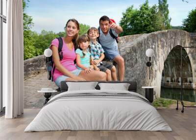 Happy family relaxing on a bridge Wall mural